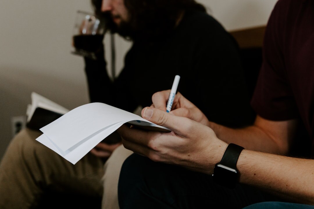 Person taking notes during a professional coaching session
